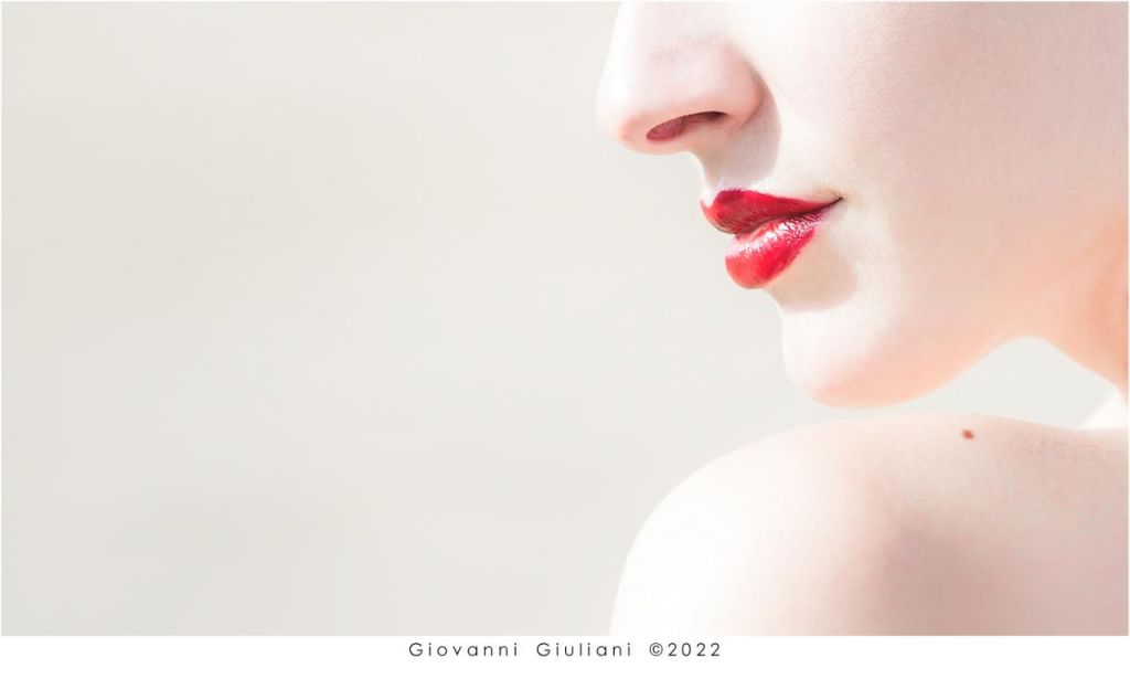 Minimalismo fotografico: labbra rosse in luce morbida